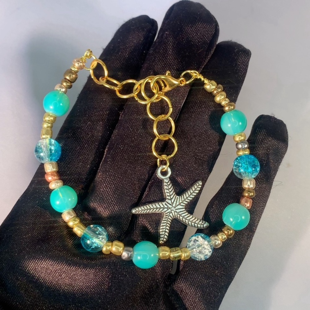 COASTAL ORBIT — Handmade Gold and Aquamarine Starfish Charm Glass Bead Bracelet